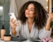 Woman with curly hair using a phone beside wash-day hair products
